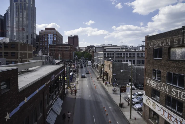 Elevated view of a downtown Nashville street lined with brick buildings and high-rises.