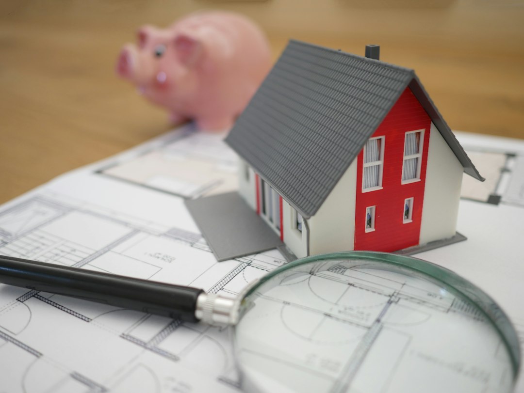 Small model house and magnifying glass on a table