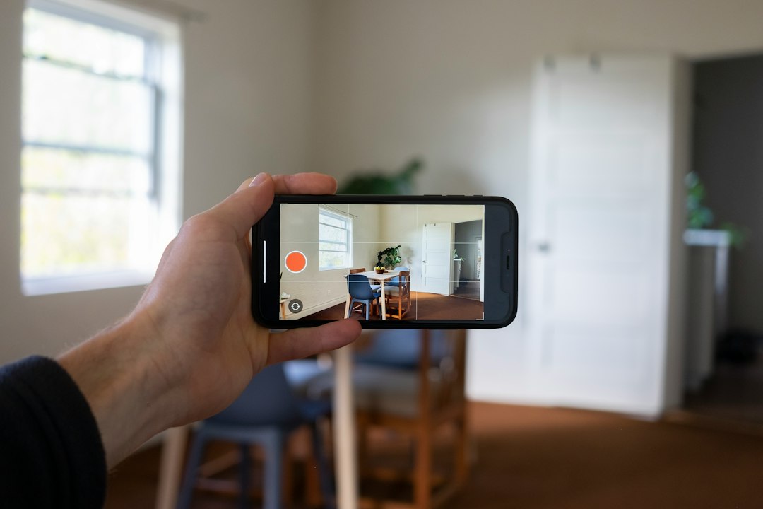Person using a phone to photograph a property