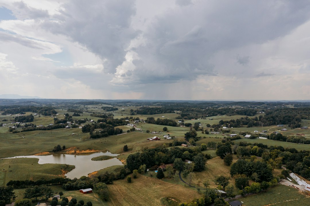 Rolling hills and farmland under a cloudy sky