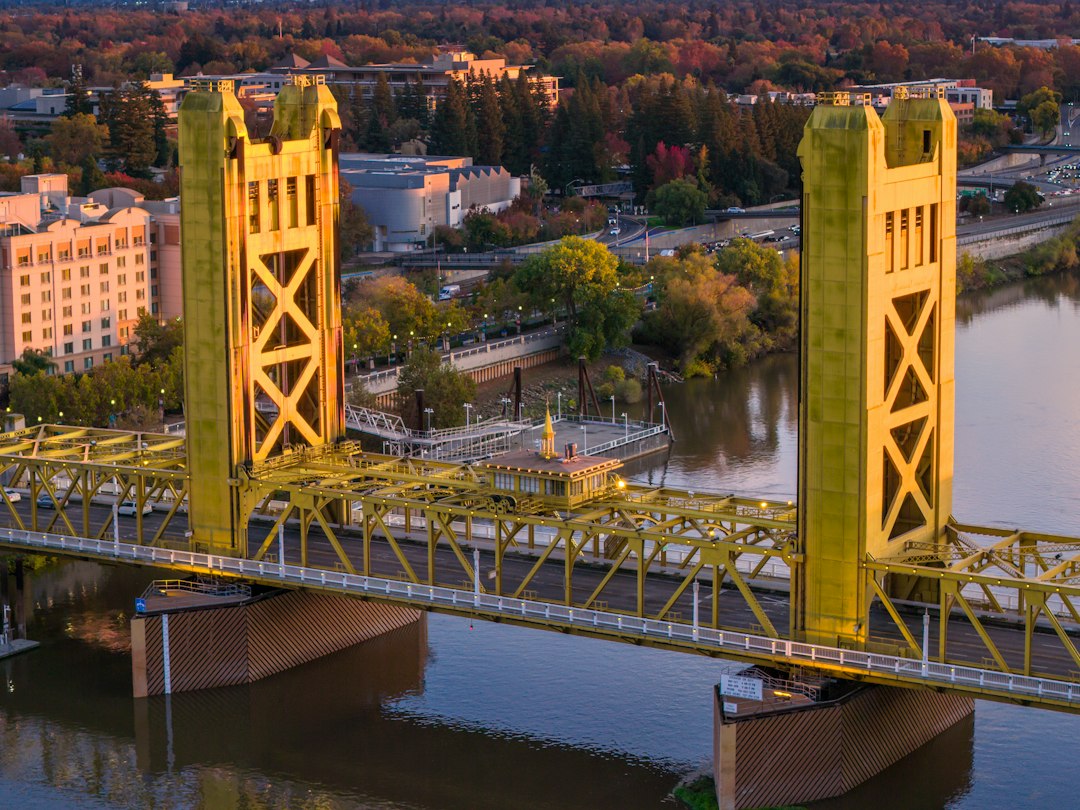 Sacramento Tower Bridge over calm water at dusk
