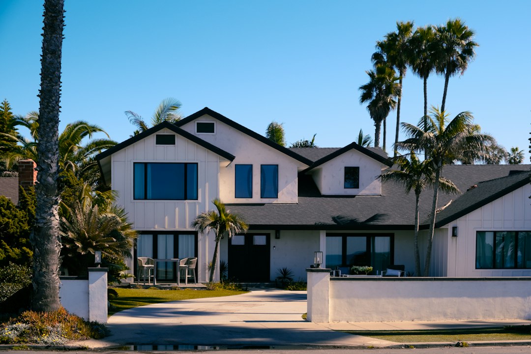 White San Diego-area house with palm trees