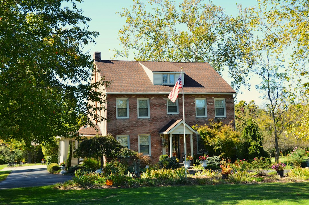 Brick country house with front lawn; illustrative stock photo