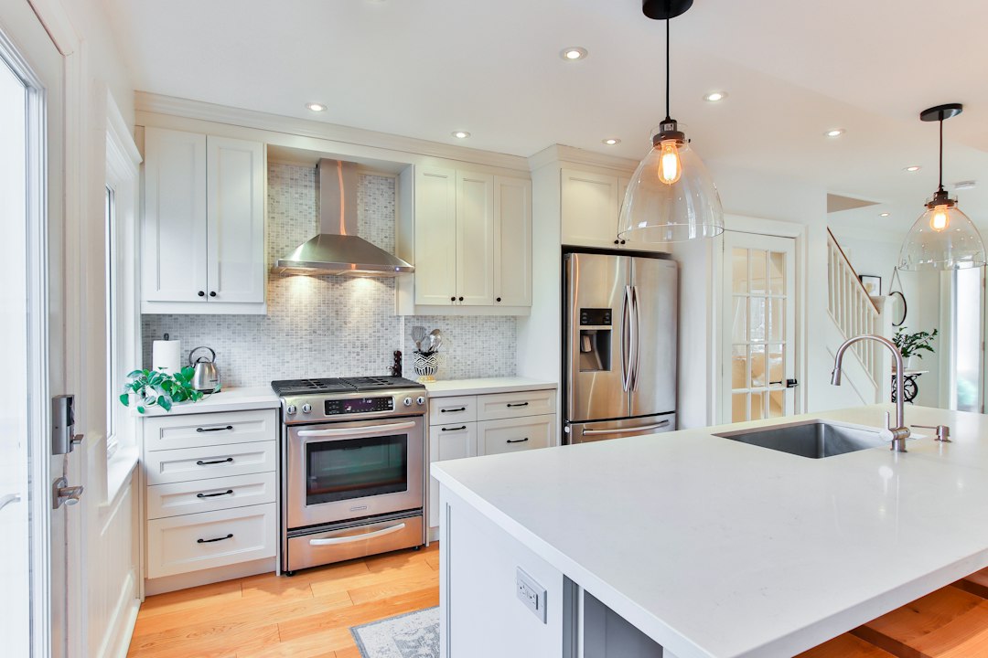 White kitchen cabinetry and counter; illustrative stock photo